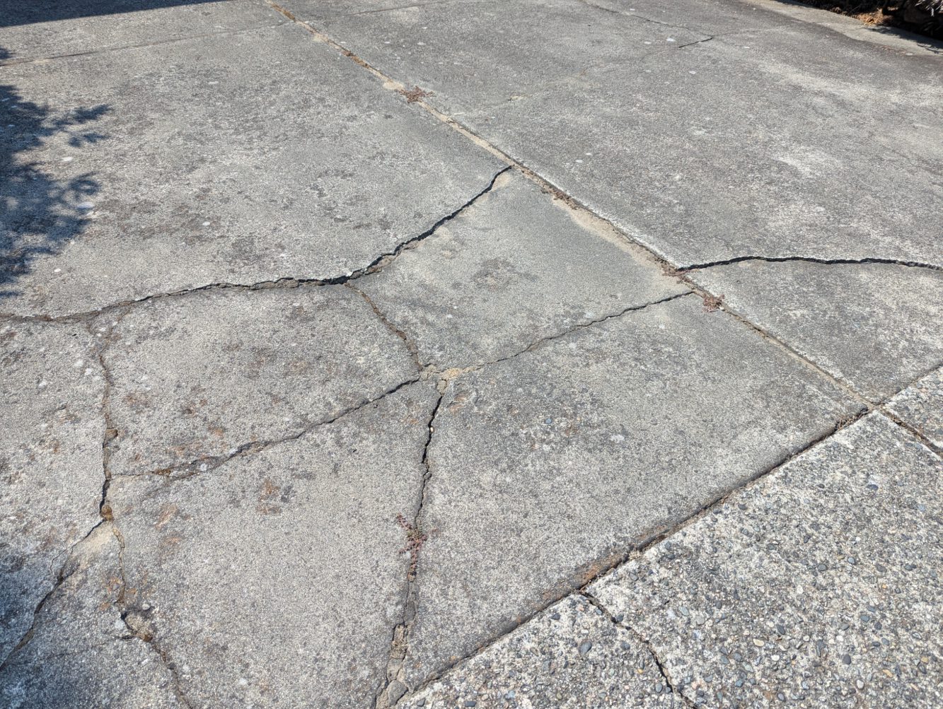cracks in concrete driveway before crack sealing