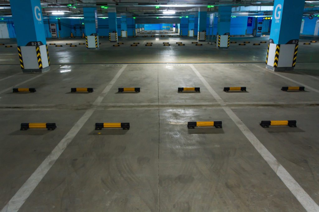 Address uneven surfaces in public parking areas to improve safety and user experience.